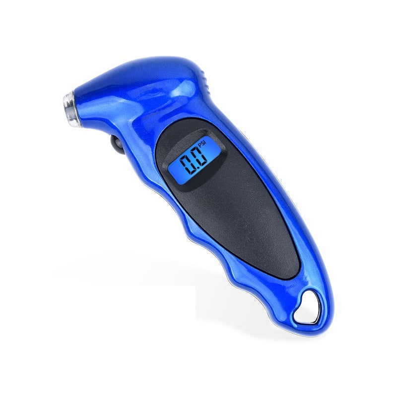 A hand holding a digital tire pressure gauge with a blue LCD screen, against the backdrop of a car tire.
